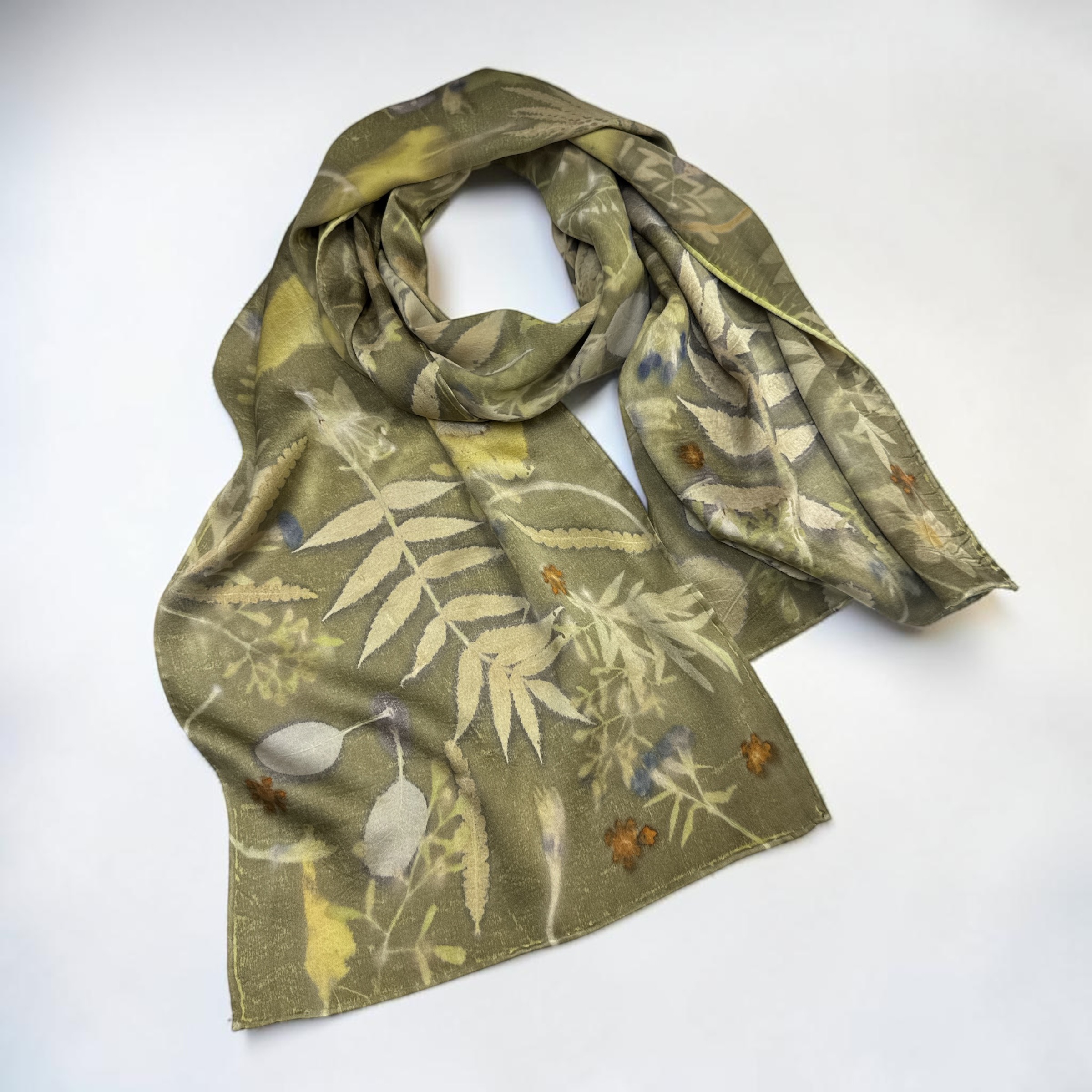 Botanically dyed silk scarf in olive green with printed leaves and ferns, by Hillary Baker