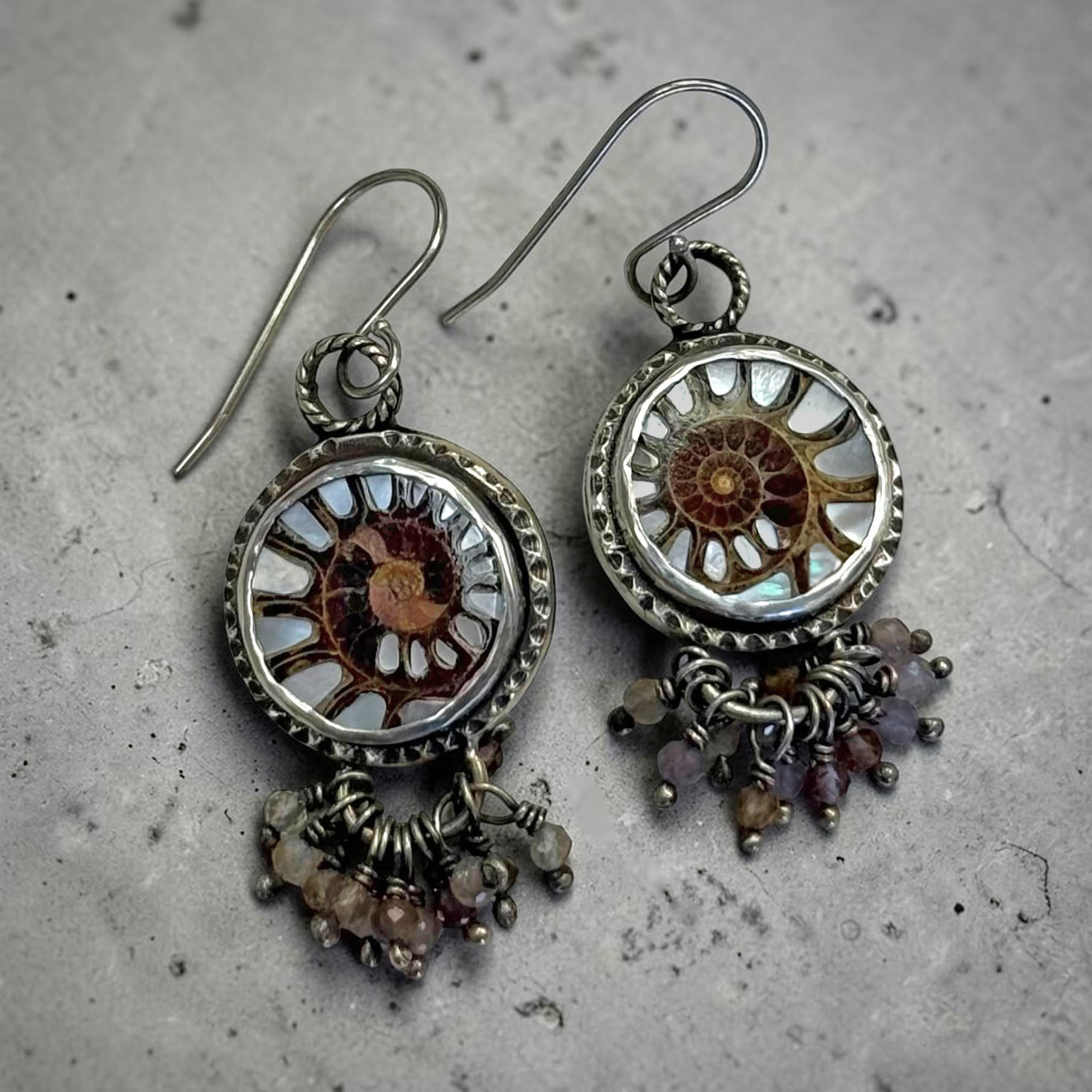 Silver earrings set with ammonite fossils and clustered stone drops, by Wendy Wetherbee