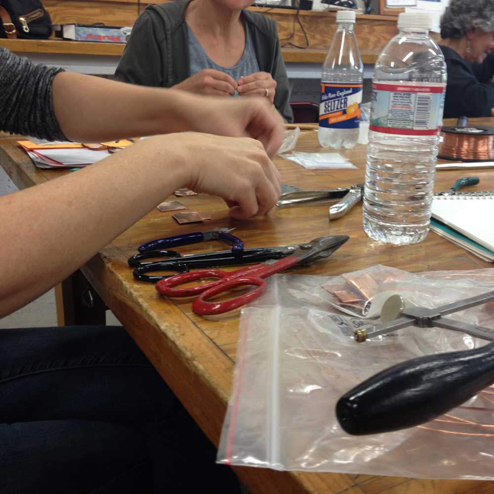 Hands at work on a piece of jewelry