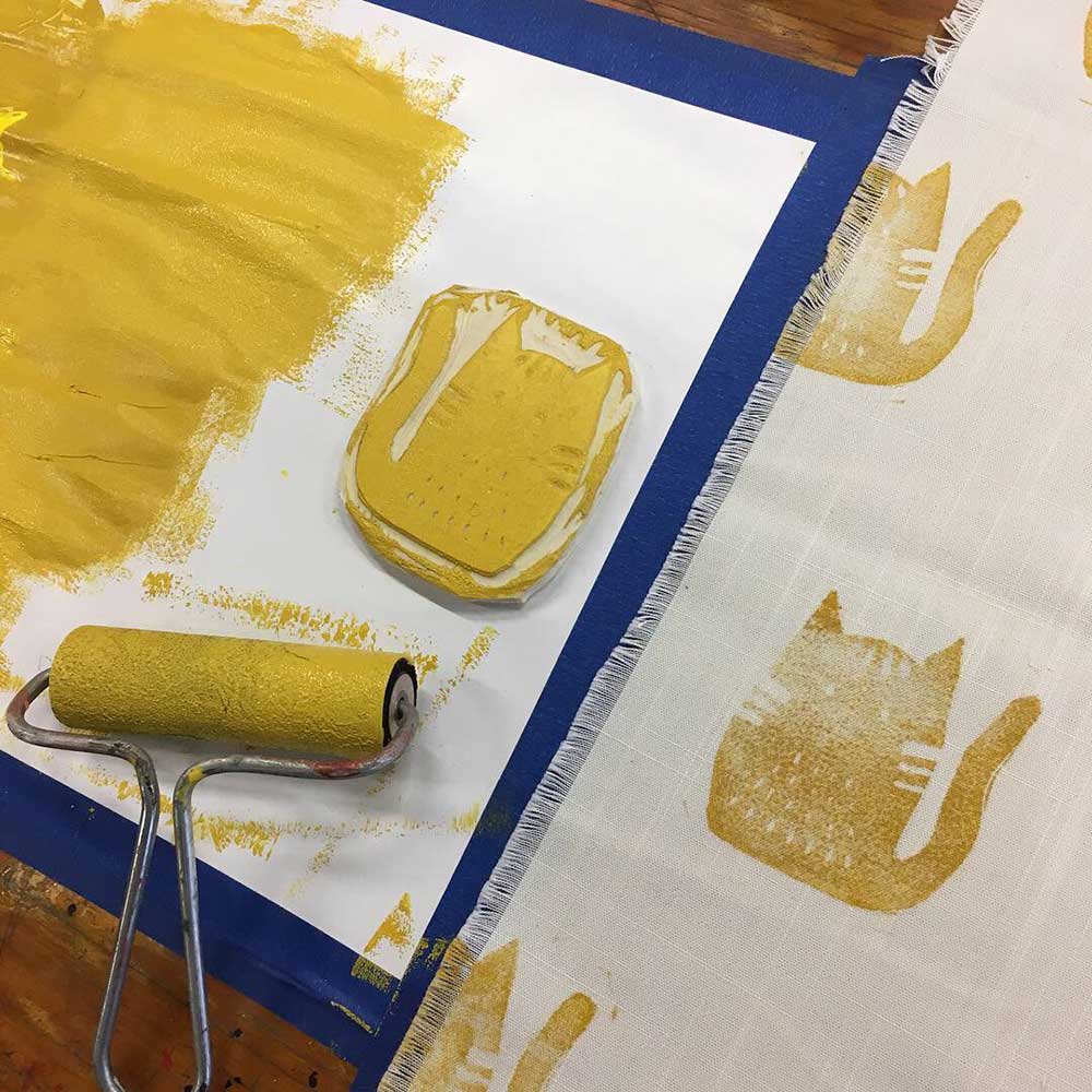 Hand printed cat designs drying